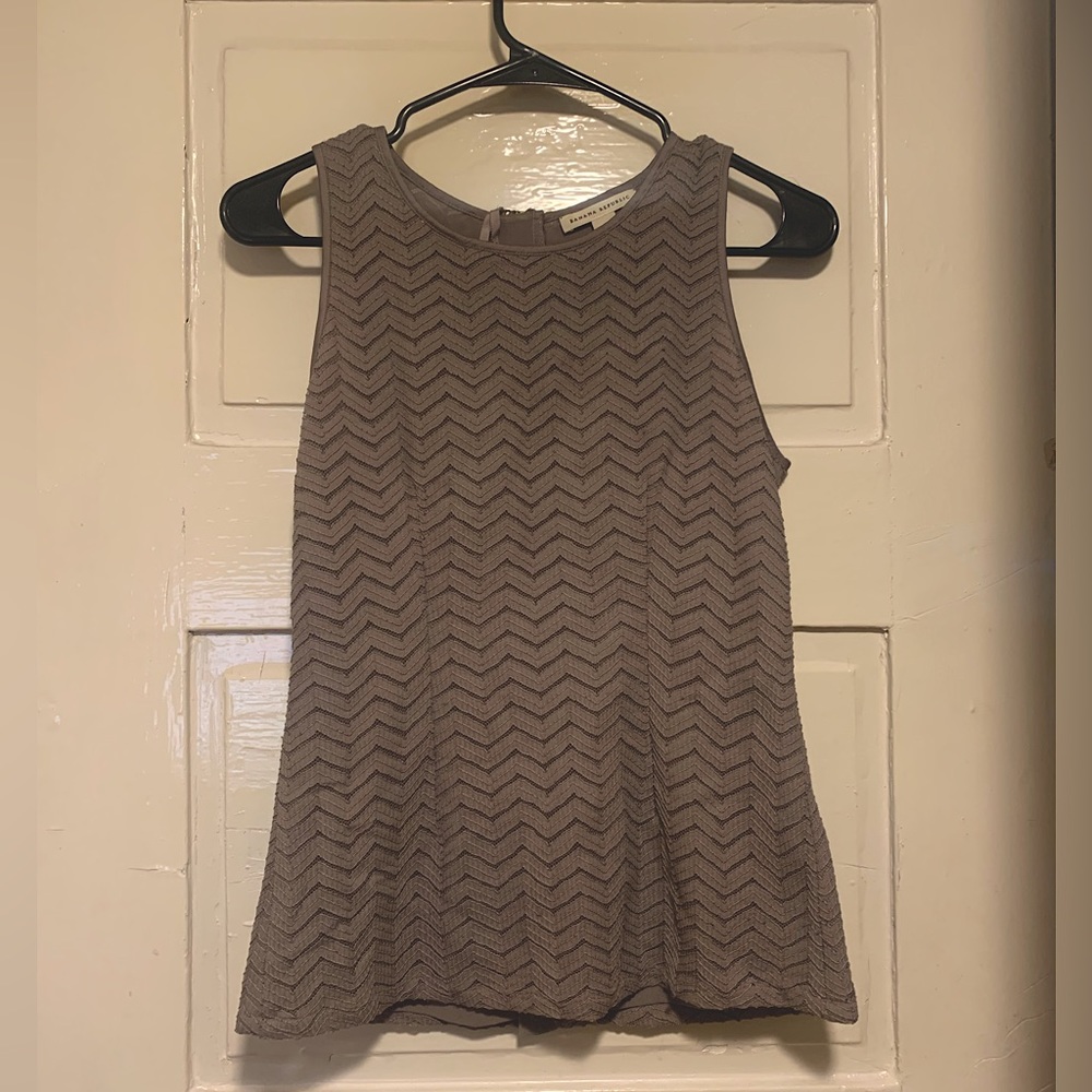 Sleeveless beige work blouse with zig zag fabric pattern
